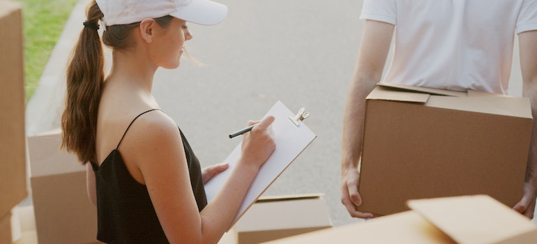 A woman making an inventory list so she can organize a last minute move in New York City