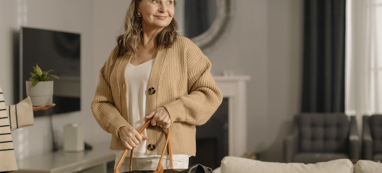 Woman holding a moving day essentials bag