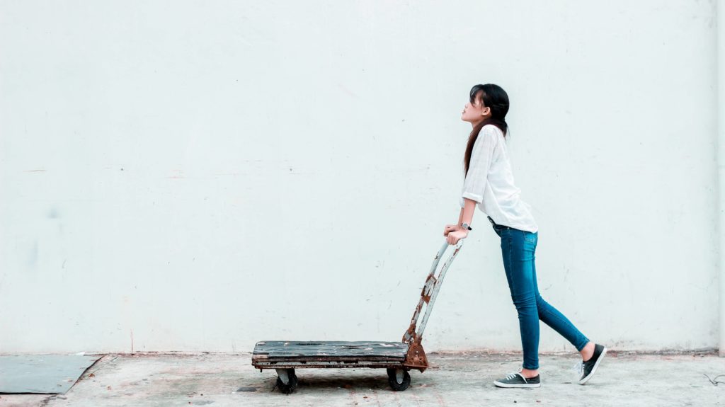 Woman pushing a dolly