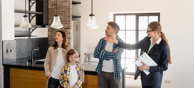 An agent showing a house to a family with a child representing moving with kids