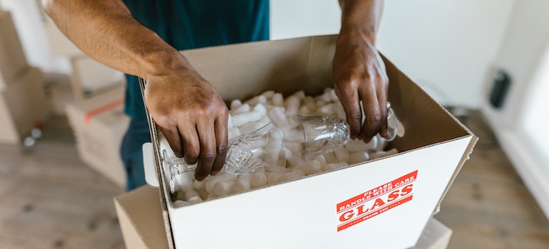 A professional packer packing crystal glasses