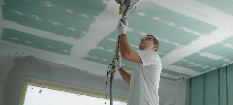 a man polishing the ceiling