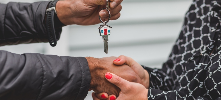 person handing the keys to another person