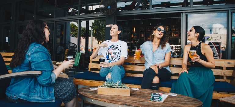 A group of people sitting and laughing in a café in NYC