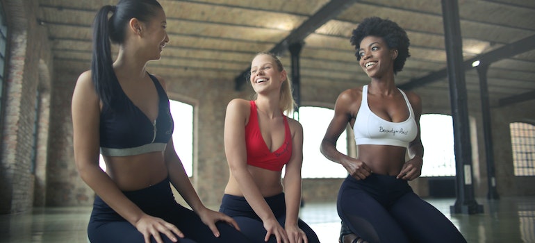 Three women laughing after the  gym workout