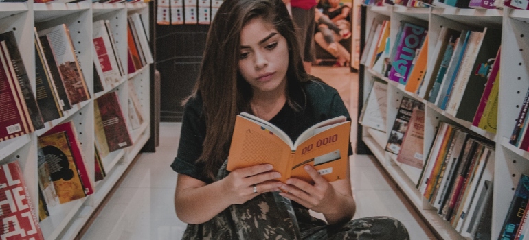 A girl reading a book in the library