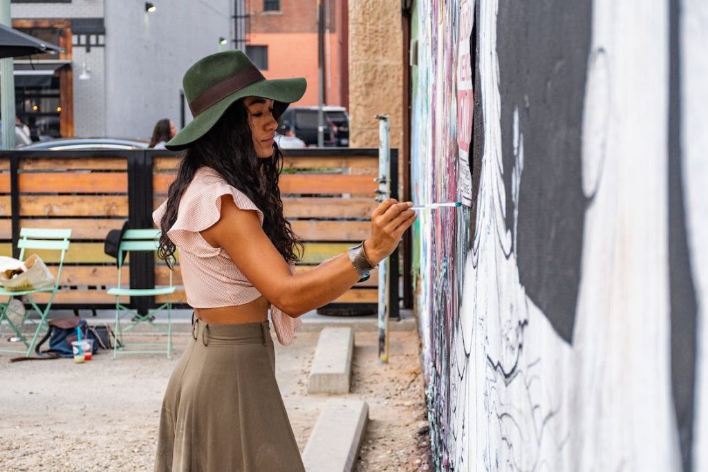 A young woman painting on the wall in Bushwick