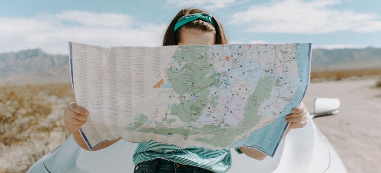 A woman looking at the map searching for the best NYC boroughs