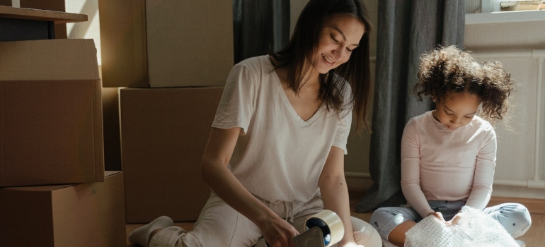 A mother and daughter packing for the move