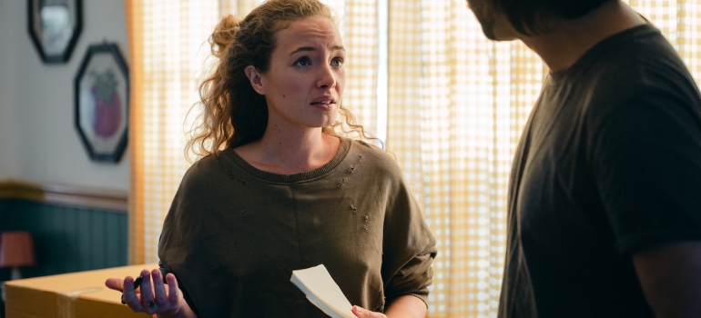 A woman holding papers explaining something to her partner