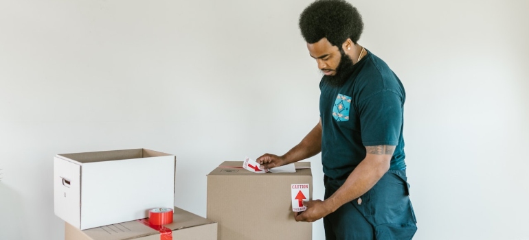 A mover labeling moving boxes