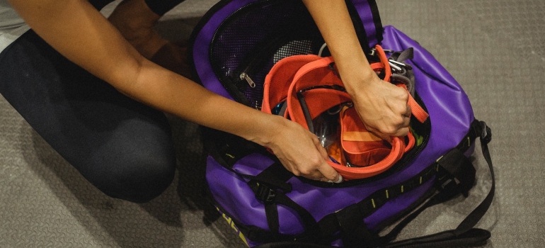 a person about to pack sports equipment