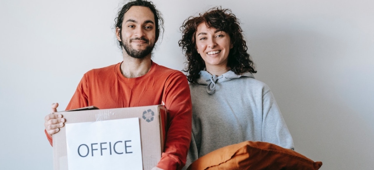 a happy couple moving a home office