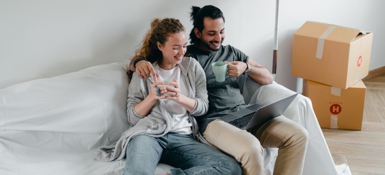 a couple searching the internet abut moving to Lower East Side