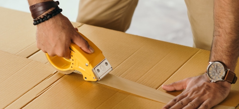 a mover packing a box