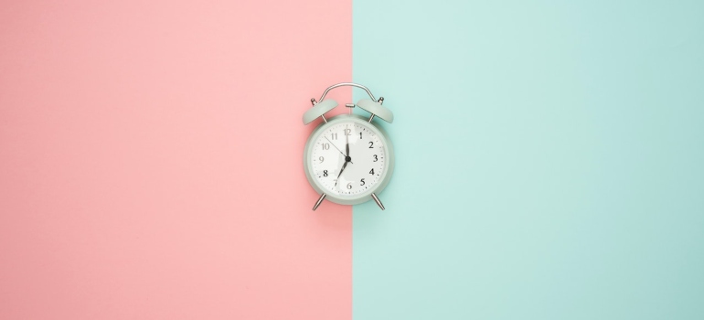 a clock on baby pink and baby blue wall