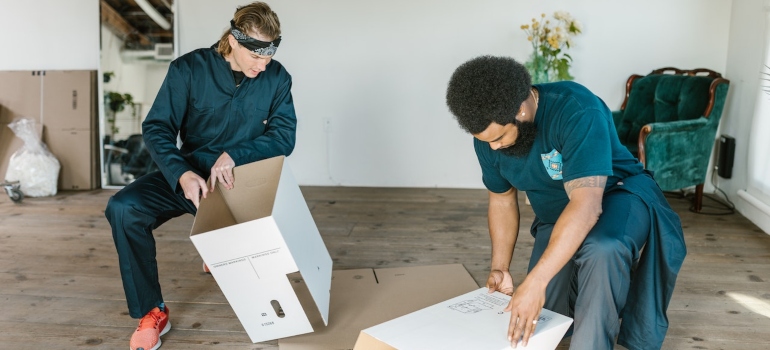 Movers making cardboard boxes