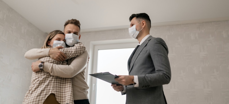 a couple wearing masks huggin