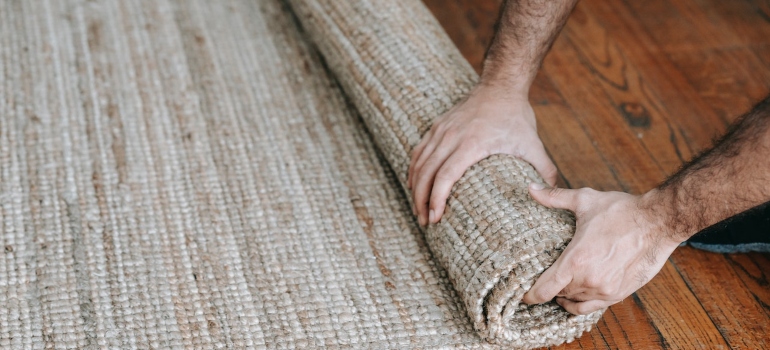 a person rolling a carpet