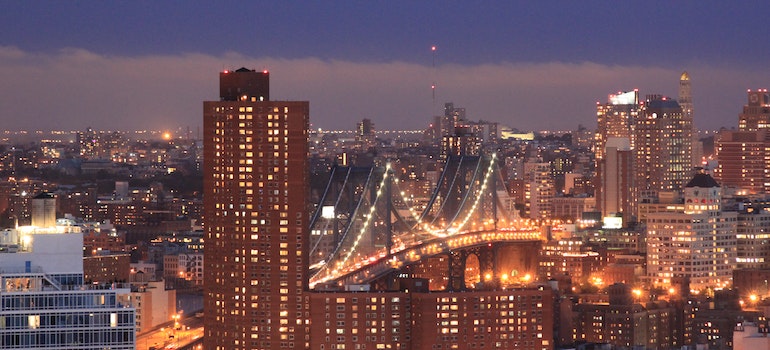 Brooklyn highrise and Brooklyn bridge at night