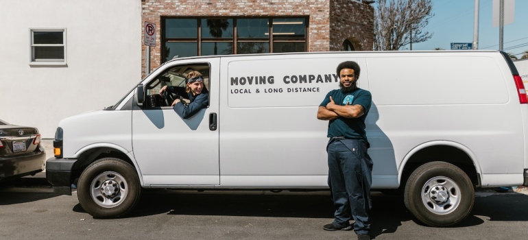 movers: one in a van, the other one next to a van