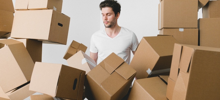 a man surrounded by a bunch of boxes