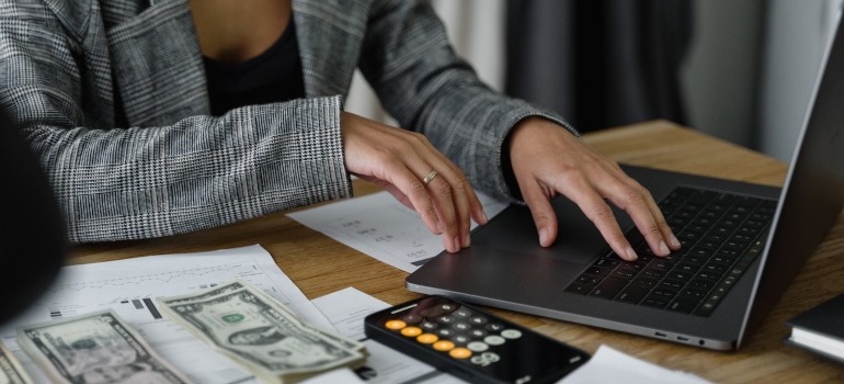 a woman calculating the cost of moving to Carol gardens with your family.