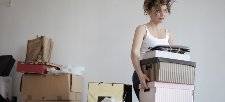 a woman carrying boxes