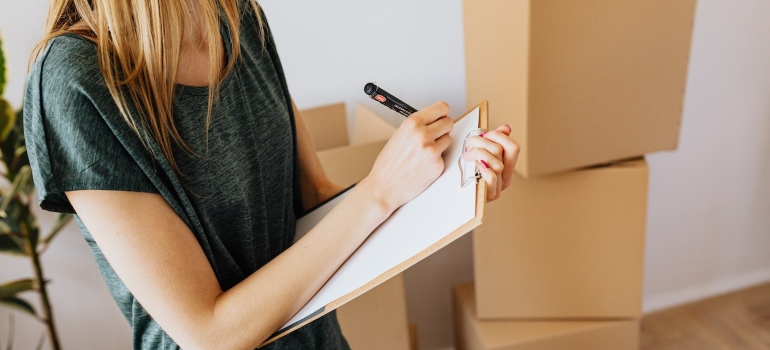 a woman making a list of items before moving to Bushwick alone