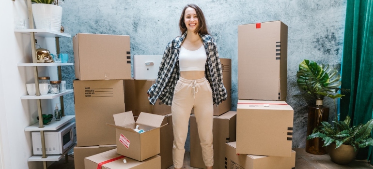a happy person surrounded by boxes