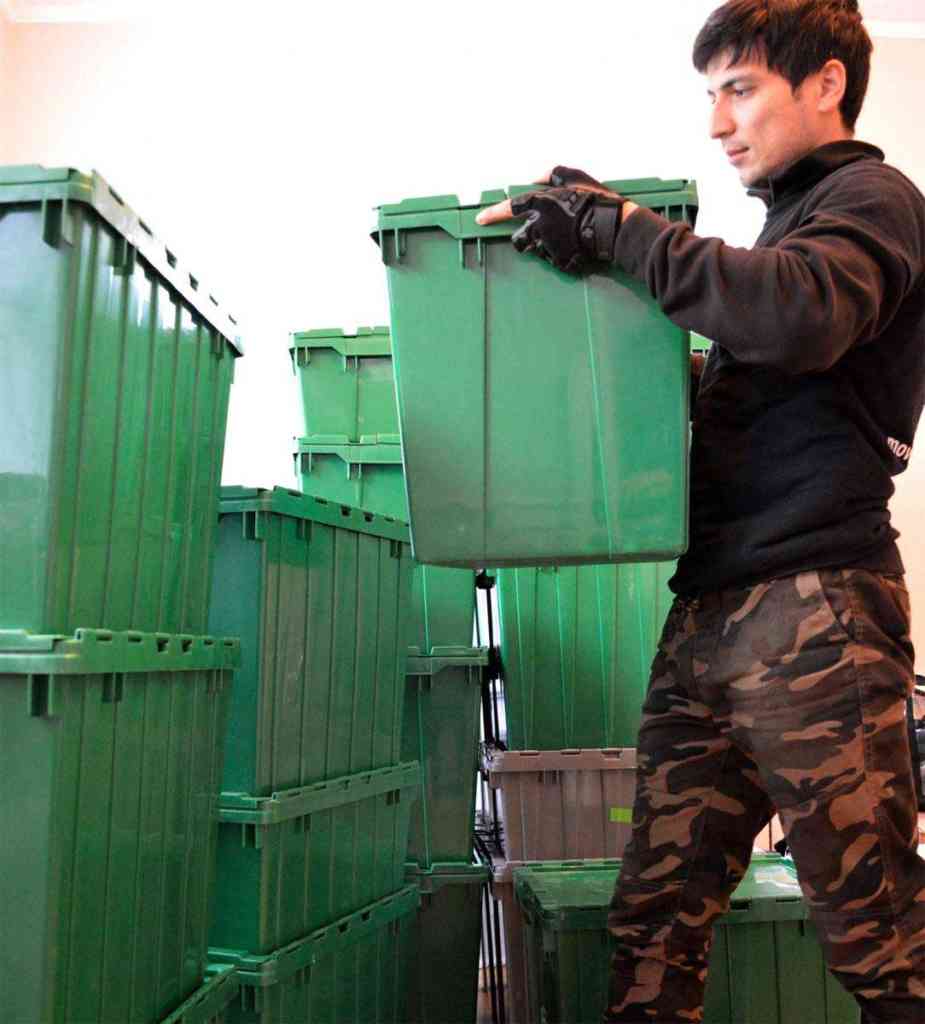 a mover with green reusable moving bins
