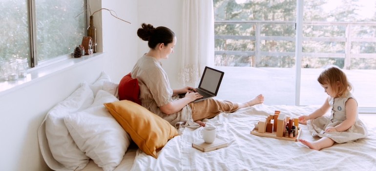 a woman with a child searching the internet for the best ways for moving to Brownsville as a single parent